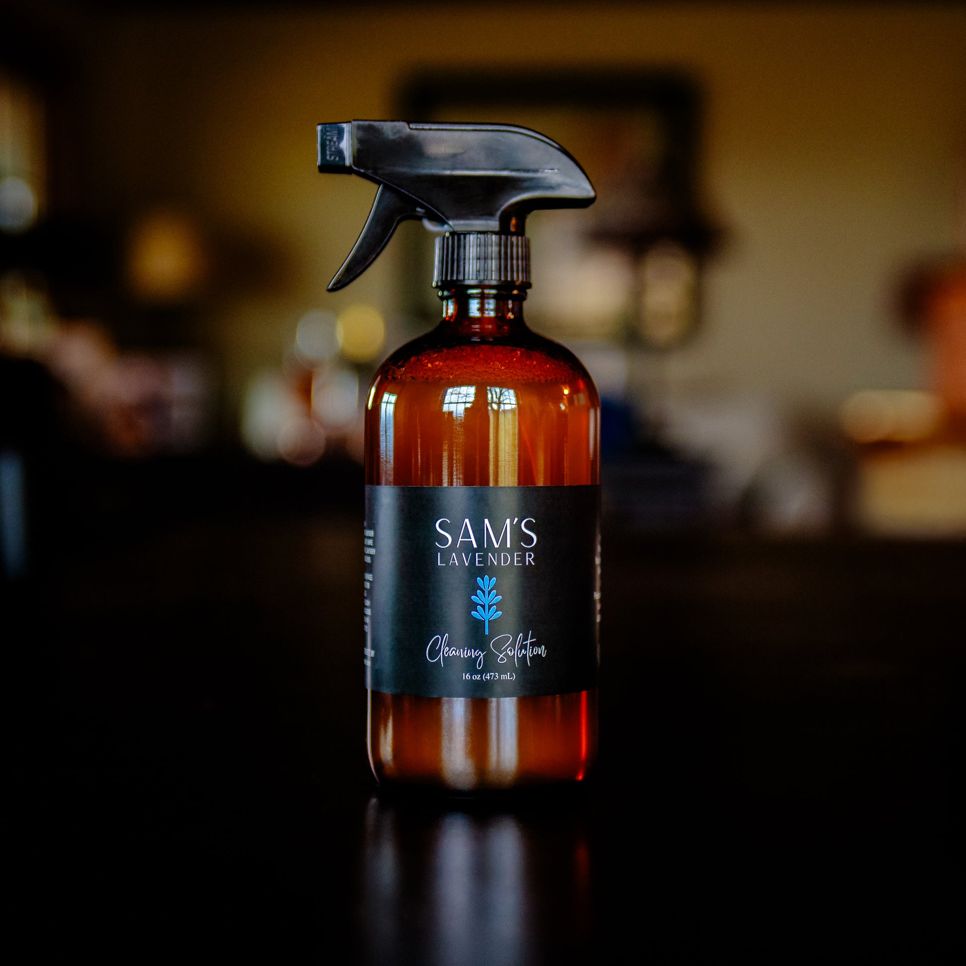 Amber glass 16oz bottle with a black trigger spray and label that reads "Sam's Lavender Cleaning Solution 16oz"