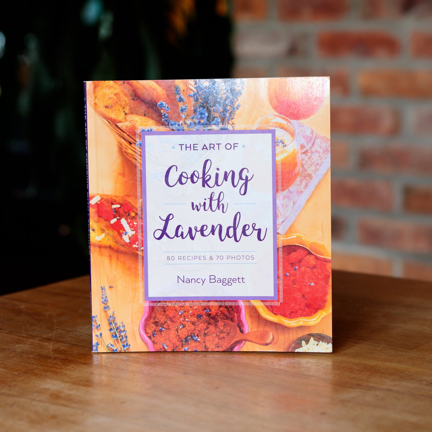 A cookbook titled 'The Art of Cooking with Lavender' by Nancy Baggett featuring photographs of food and lavender on the cover.