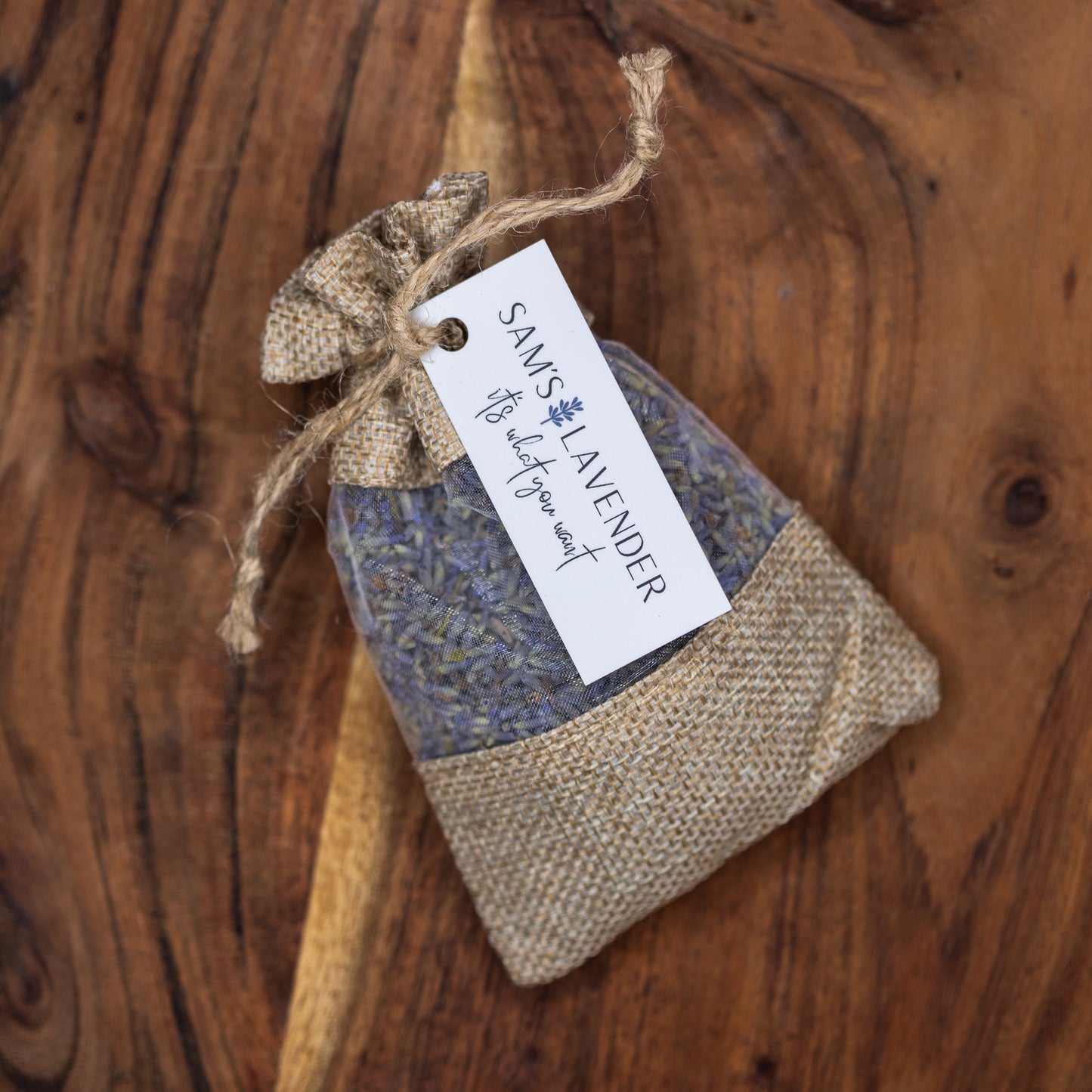 One natural brown linen sachet with a muslin window revealing lavender buds.