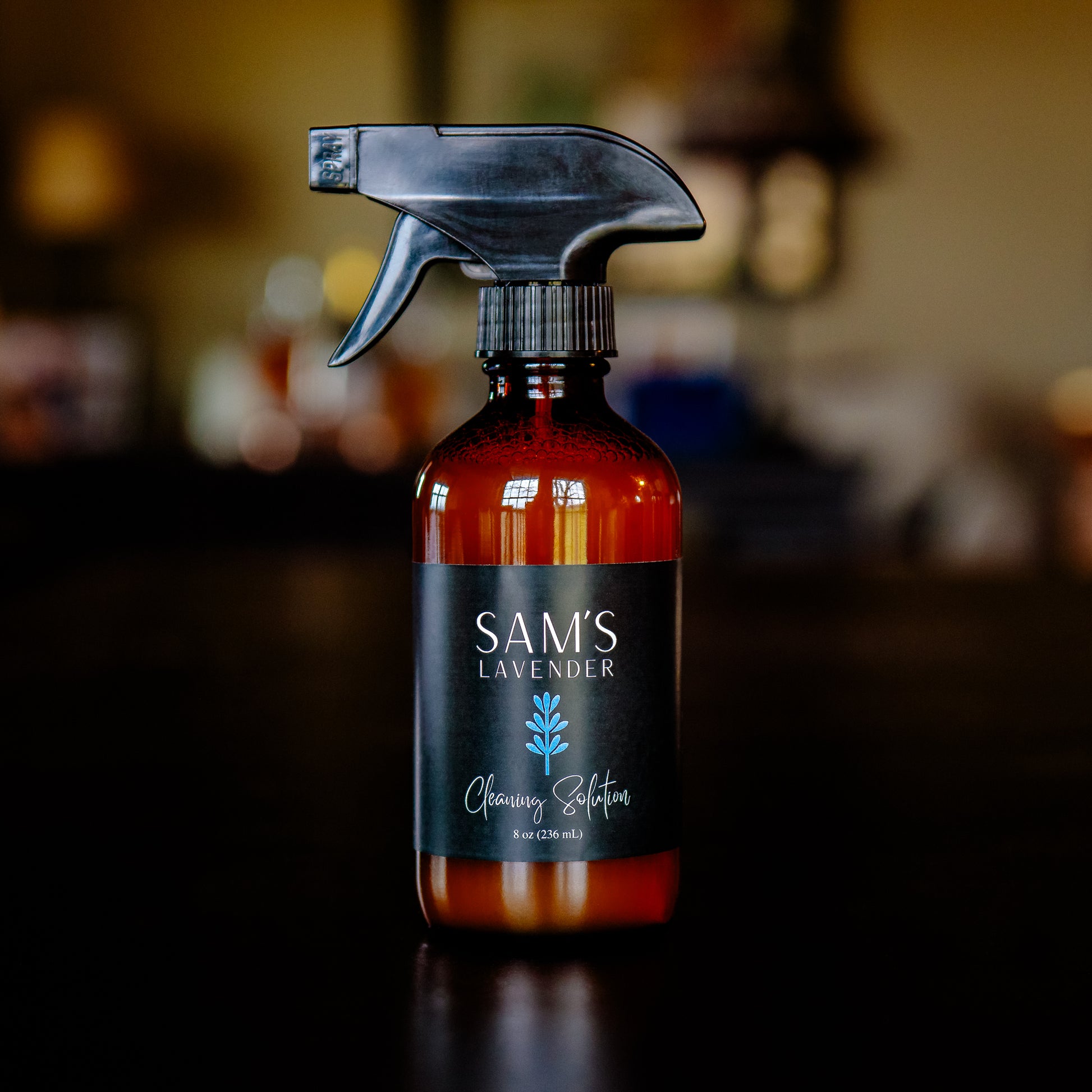 Amber glass 8oz bottle with a black trigger spray and label that reads "Sam's Lavender Cleaning Solution 8oz"
