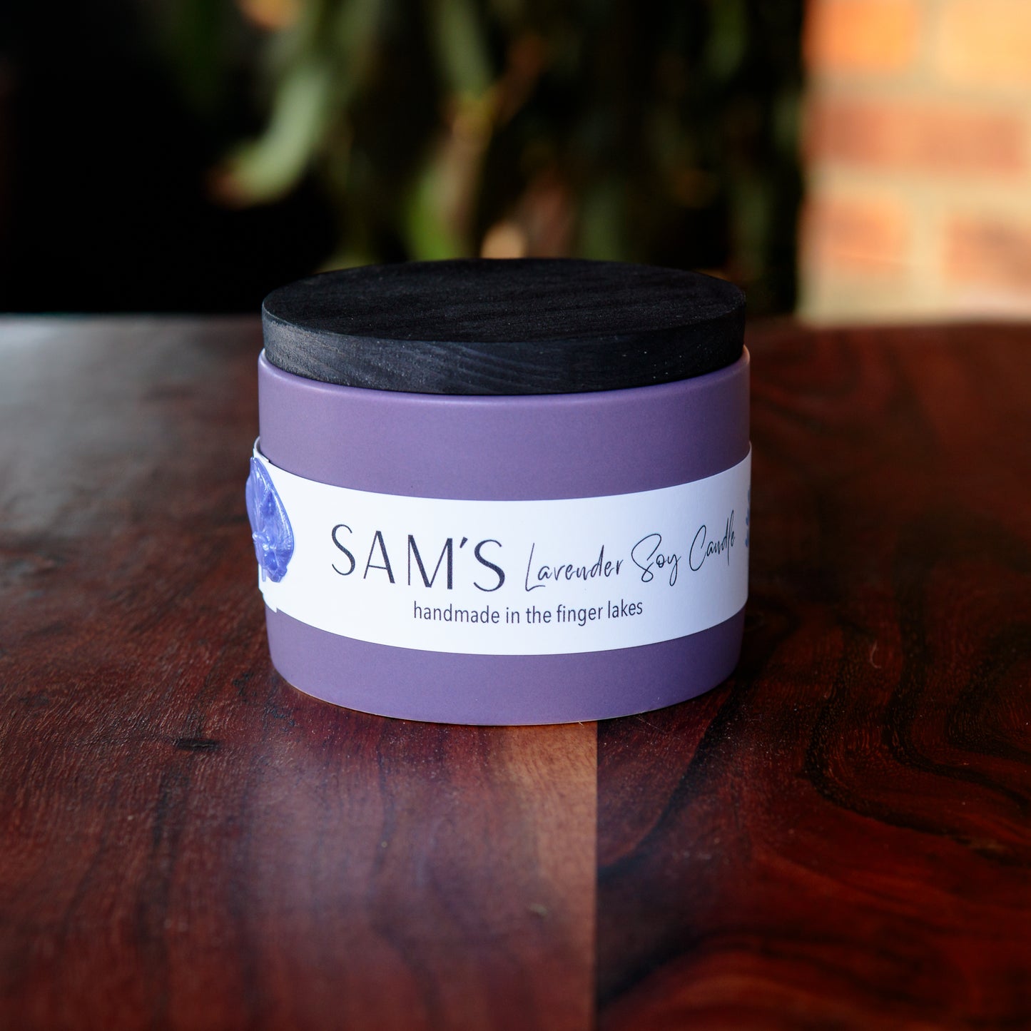 lavender soy candle with black wooden lid