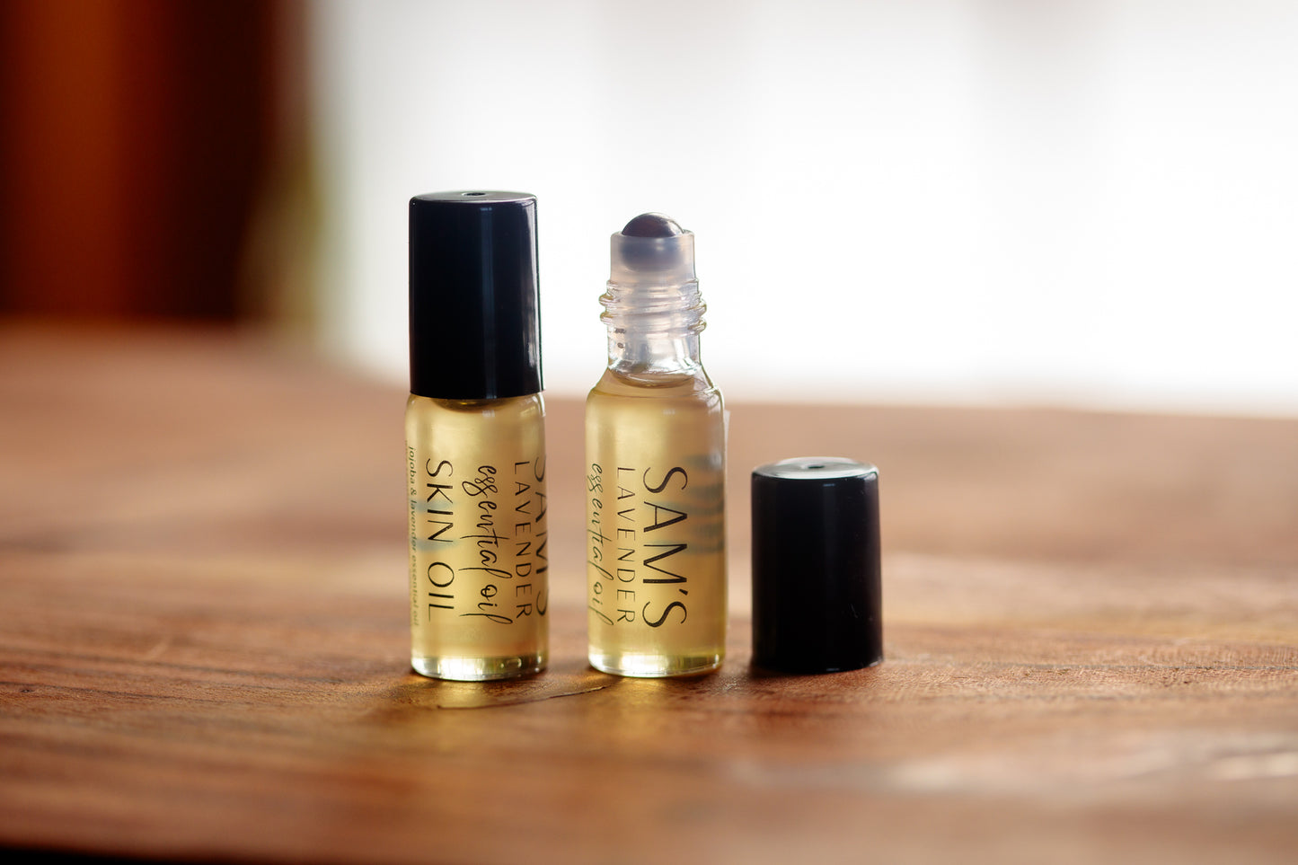 two glass roller balls labeled "Sam's Lavender Essential Oil Skin Roller" 5mL with black caps