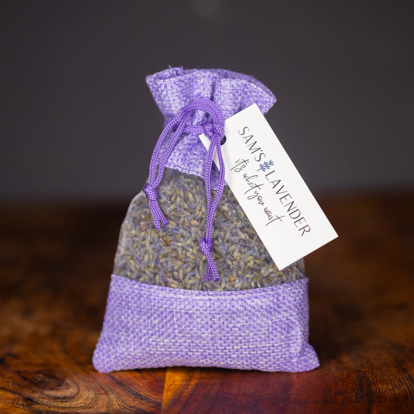 One lavender linen sachet with a muslin window revealing lavender buds.