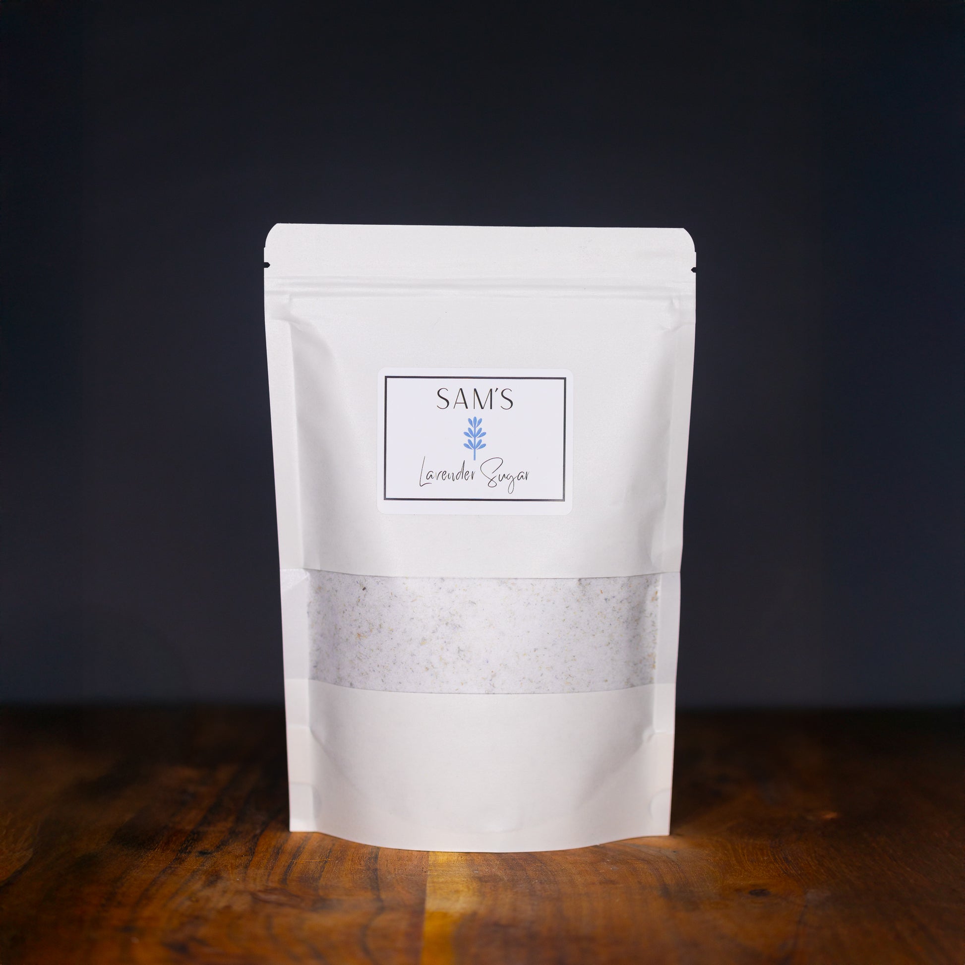 White resealable paper pouch labeled "Sam's Lavender Sugar" containing 8-16 oz of lavender sugar.