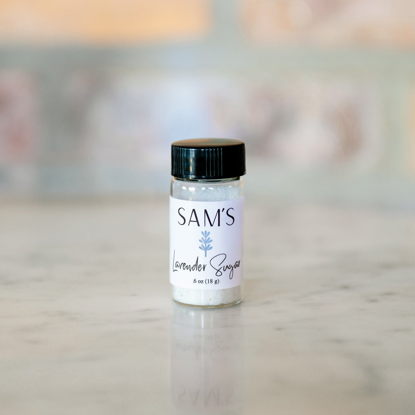 A glass jar labeled 'Sam's Lavender Sugar' filled with lavender sugar.