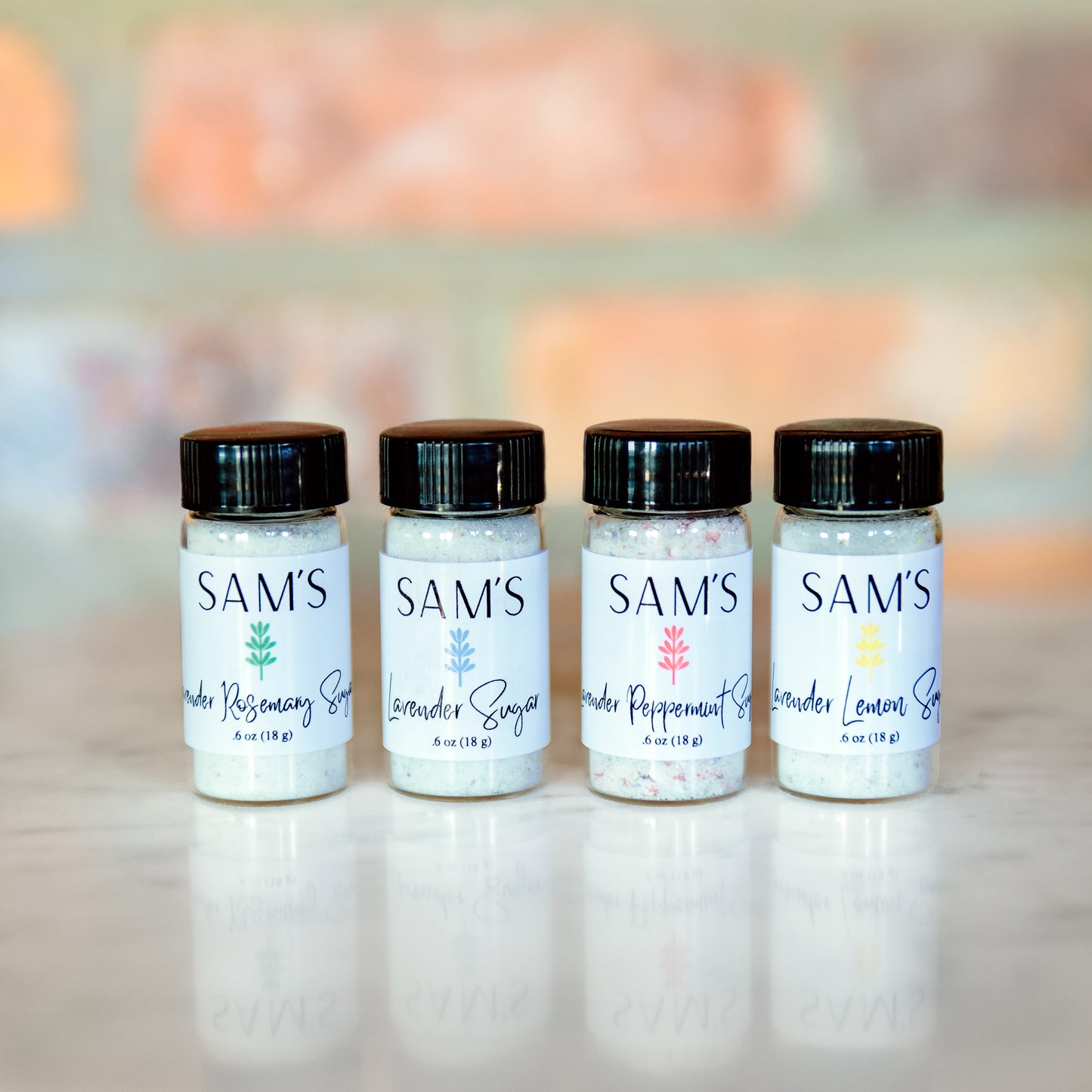 Four different lavender sugar flavors in small glass vials.