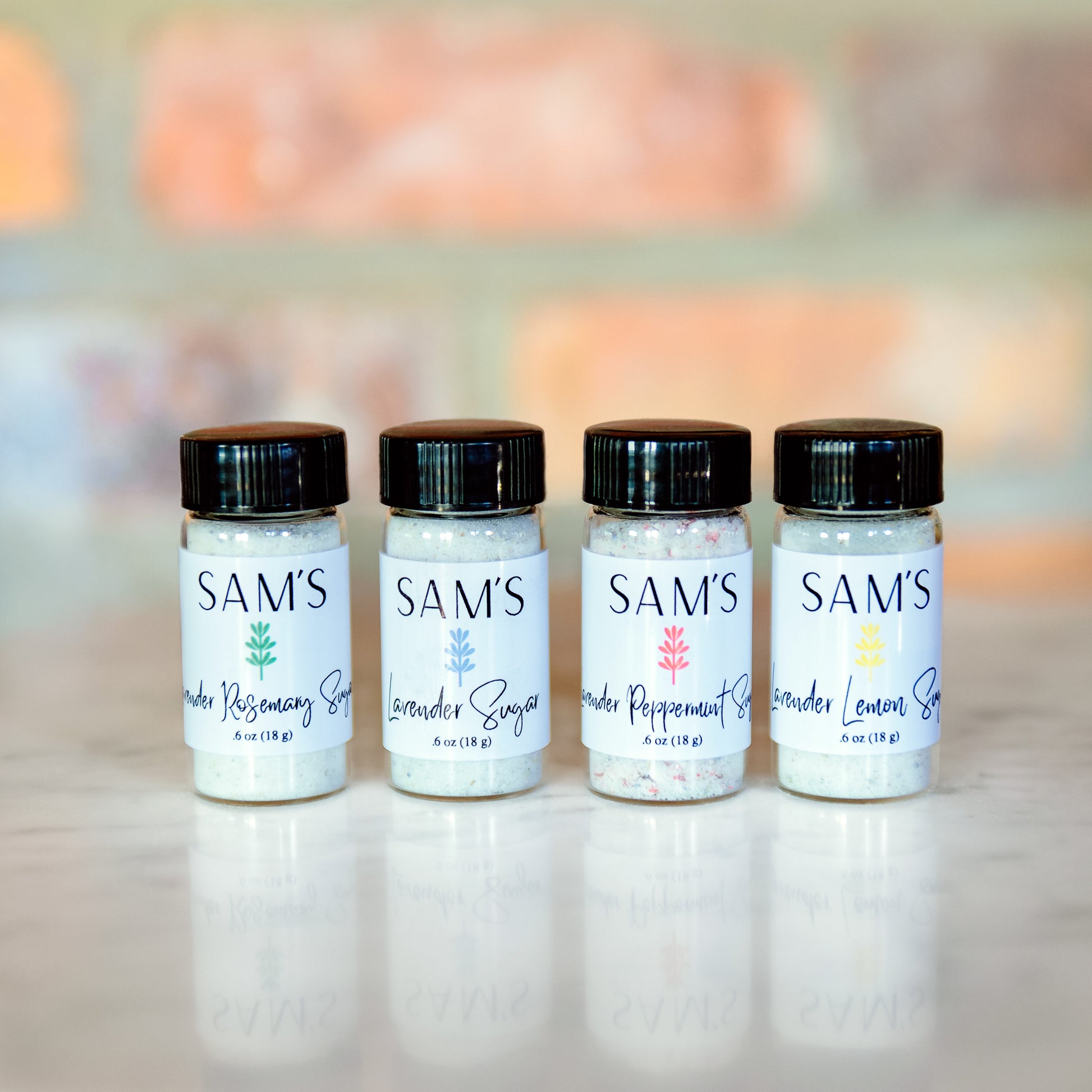 Four different lavender sugar flavors in small glass vials.